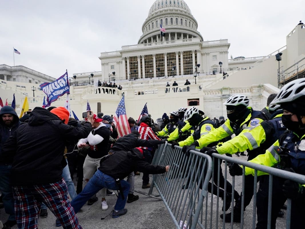 Violent insurrections loyal to President Donald Trump break through a police barrier at the Capitol in Washington on Jan. 6, 2021.
