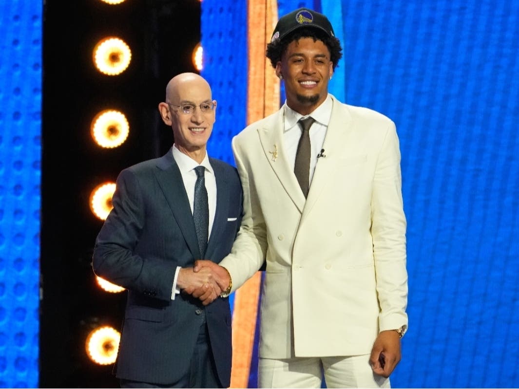 Yaxel Lendeborg, left, poses for a photo with NBA Commissioner Adam Silver, left, after being selected by the Golden State Warriors as the 11th in the first round of the NBA basketball draft, Tuesday, June 23, 2026, in New York.