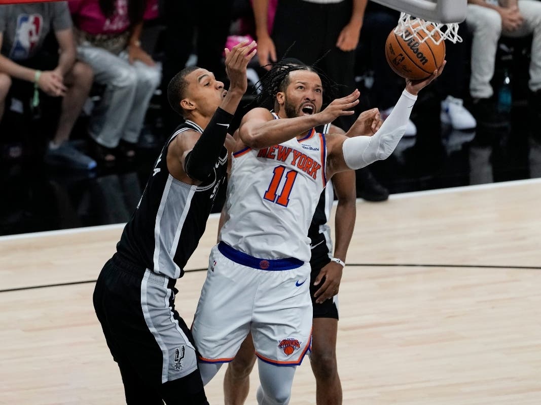 New York Knicks guard Jalen Brunson (11) drives past San Antonio Spurs forward Victor Wembanyama, left, during the first half of Game 1 of the NBA Finals basketball series, Wednesday, June 3, 2026, in San Antonio.