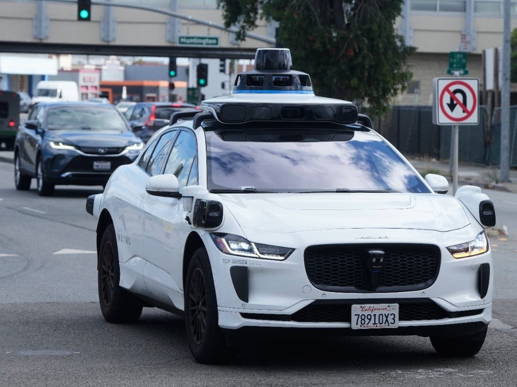 A Waymo vehicle drives past a No U-Turn sign in San Bruno, Calif., Tuesday, Sept. 30, 2025.