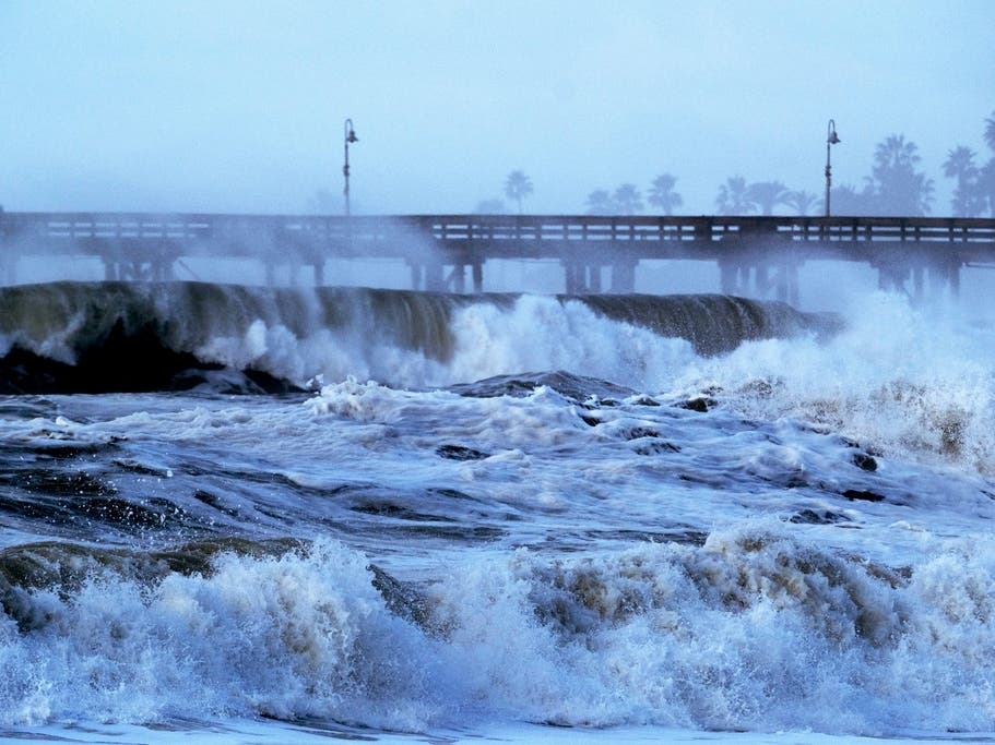 Large waves crash along the Southern California coast. Scientists are tracking a Kelvin wave that could raise coastal sea levels in the coming weeks.