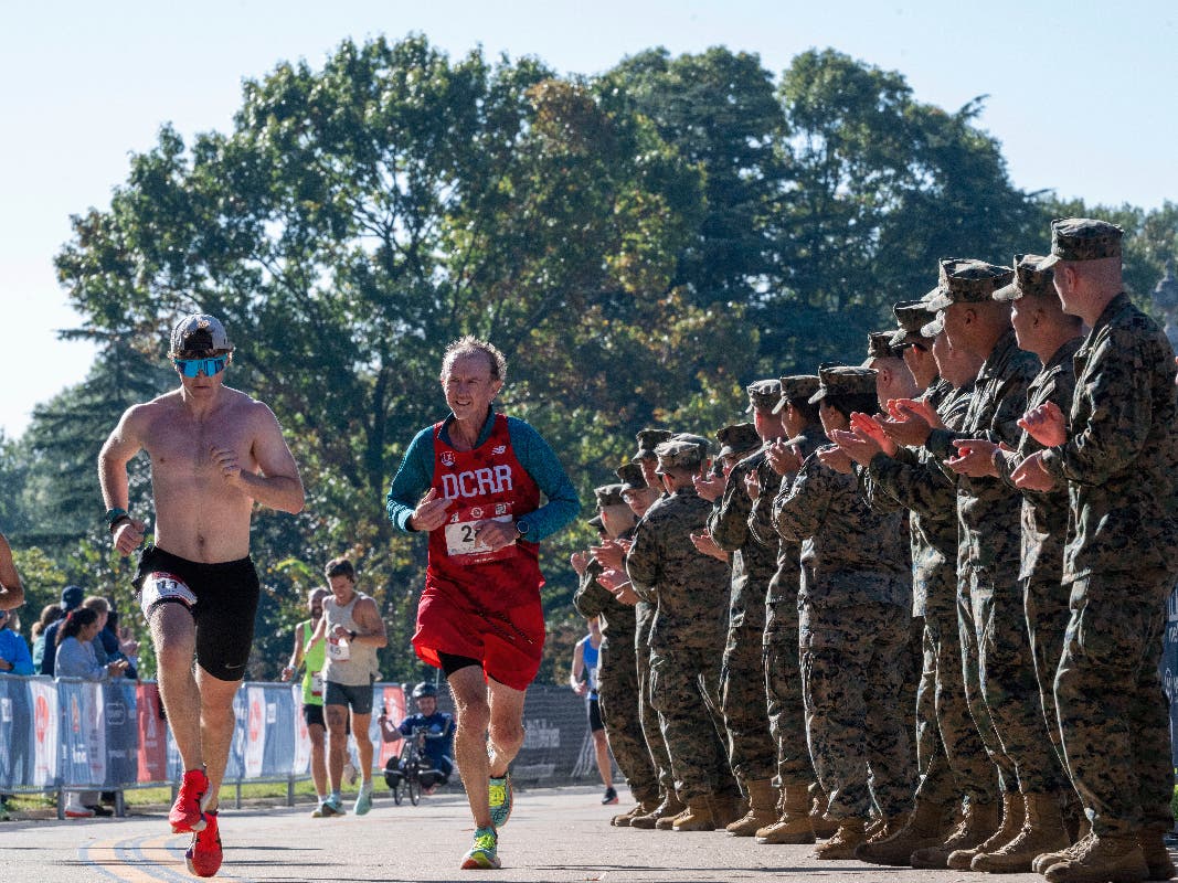 Marines cheer on participants near the finish line of the 51st annual Marine Corps Marathon, Sunday, Oct. 25, 2026 in Arlington, Va. (AP Photo/Kevin Wolf)