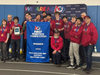 Team Apple Pi with their championship medals and team banner after winning the tournament at the 2026 Hartford District Event. 