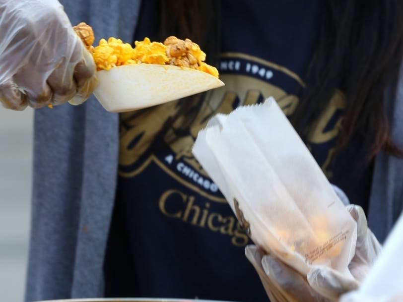 Garrett Popcorn Shops teammates celebrate the 65th anniversary by handing out complimentary bags of the world famous Garrett Mix throughout the city via a trolley on Thursday, Sept. 18, 2014 in Chicago, Illinois. 