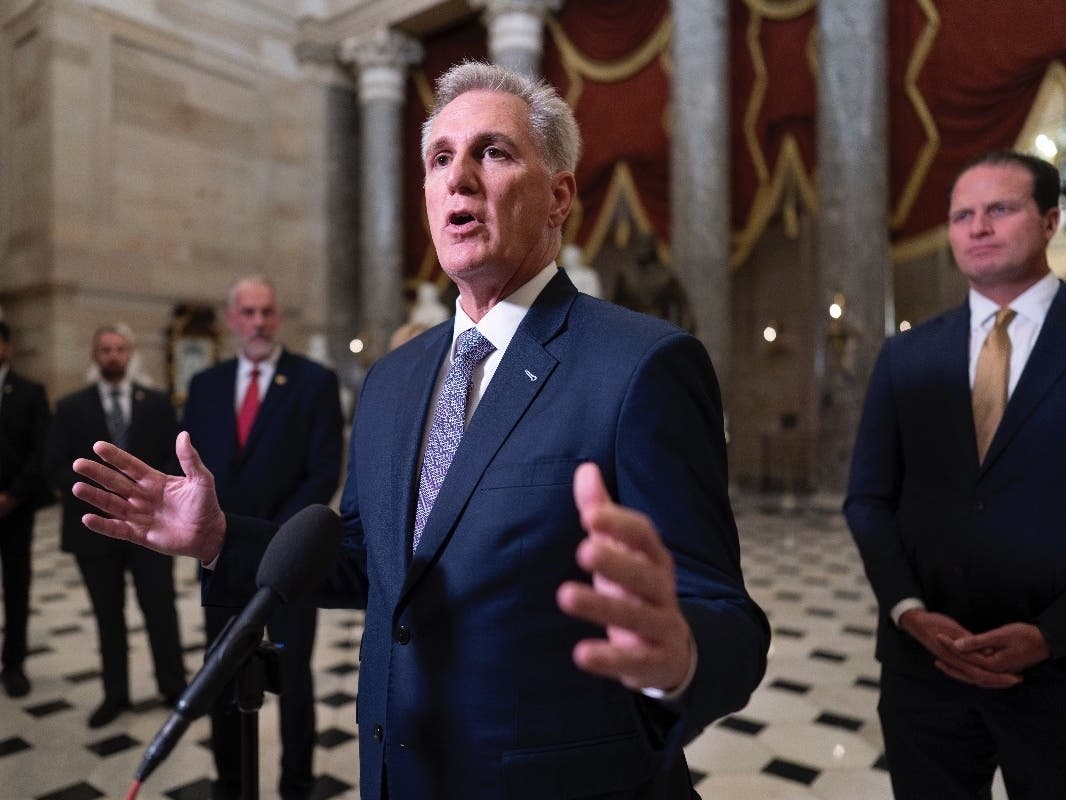 House Speaker Kevin McCarthy, R-Calif., joined by Rep. August Pfluger, R-Texas, right, and other GOP members, talks to reporters just after voting to advance appropriations bills on the House floor, at the Capitol in Washington on Sept. 26.