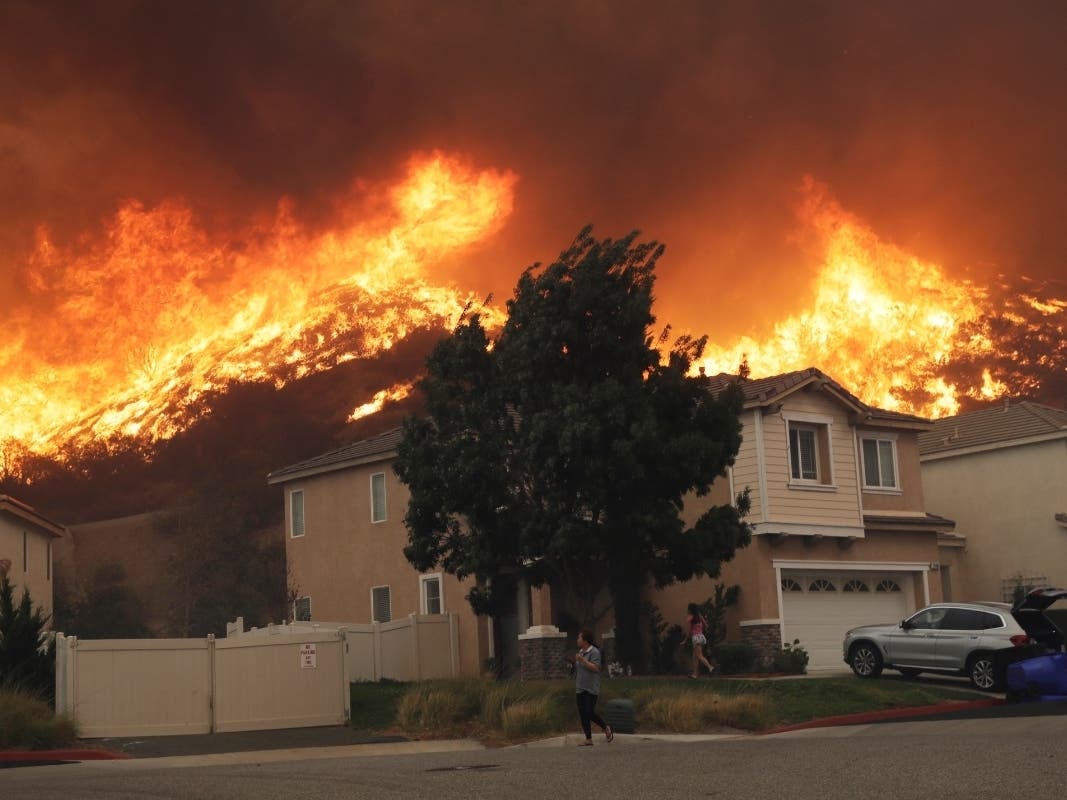 A wildfire-ravaged home burns as crews continue to battle the Getty fire on Monday in Los Angeles.