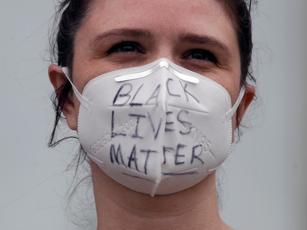 Annah Dominis wears a face mask with Black Lives Matter written on it, in San Francisco, Saturday, May 30, 2020, at a protest over the Memorial Day death of George Floyd. 