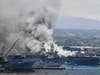 Smoke rises from the USS Bonhomme Richard at Naval Base San Diego Sunday, July 12, 2020, in San Diego after an explosion and fire Sunday on board the ship at Naval Base San Diego. 