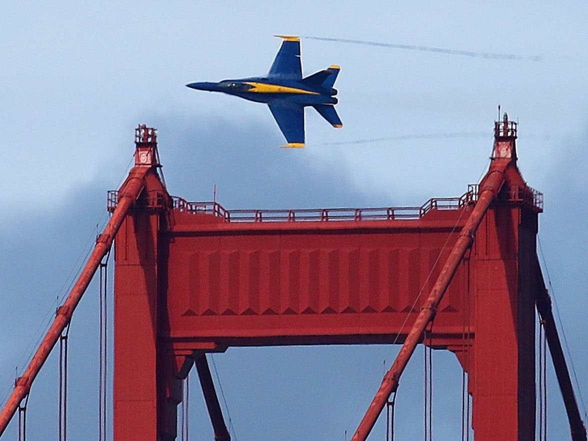 A U. S. Navy Blue Angel flies over the south tower of the Golden Gate Bridge during practice Thursday, Oct. 4, 2018, in San Francisco.