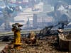 A fire official looks over the scene of a small plane crash, Monday, Oct. 11, 2021, in Santee, Calif. 