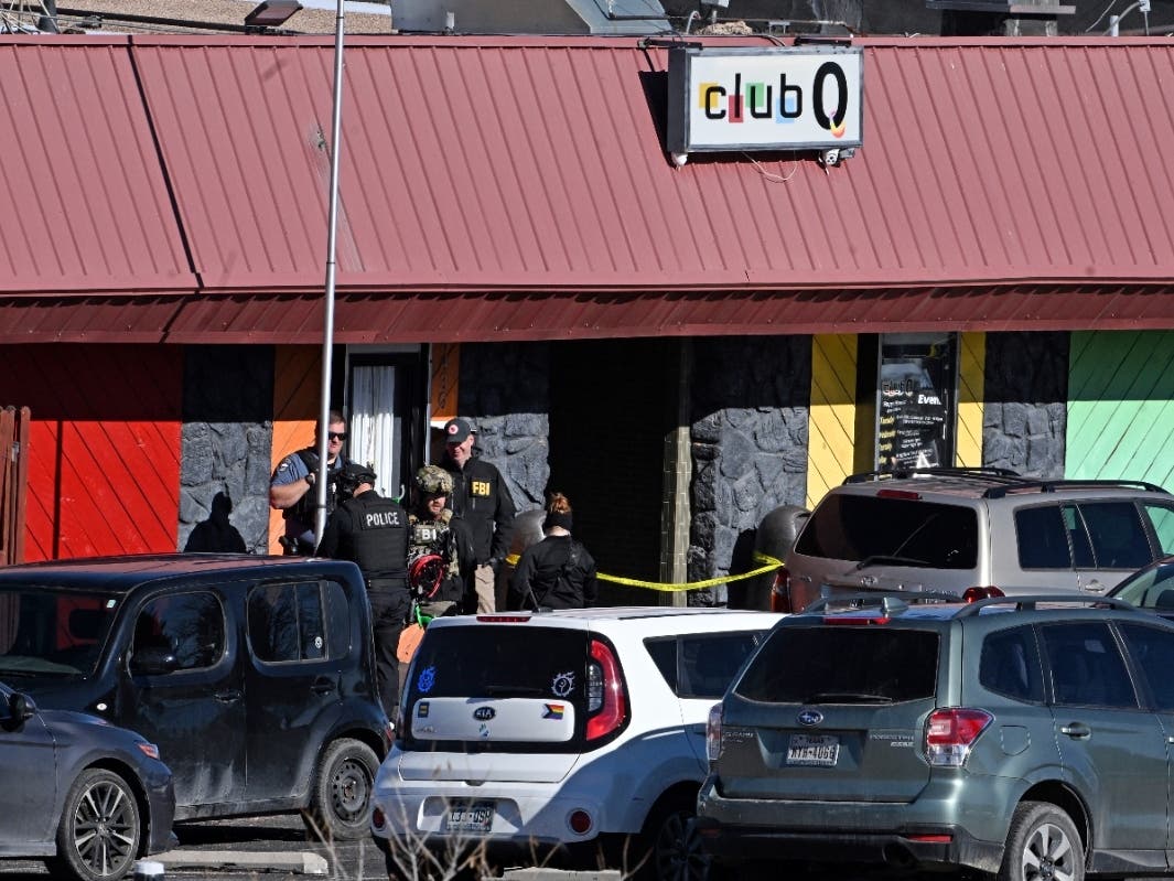Colorado Springs police, the FBI and others investigate the scene of a shooting at Club Q on Sunday, Nov. 20, 2022 in Colorado Springs, Colo. An attacker opened fire in a gay nightclub late Saturday night.
