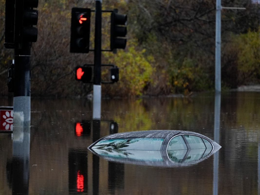 A car sits along a flooded road during a rain storm Jan. 22, 2024, in San Diego.