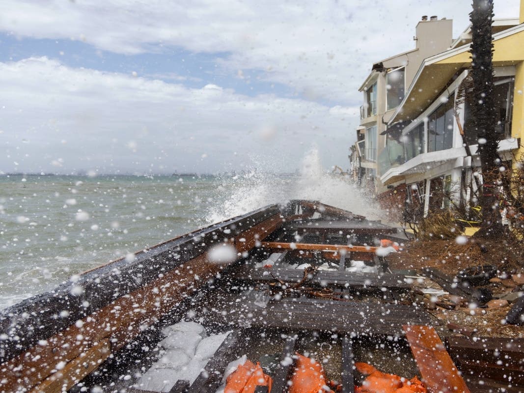 Waves crash by homes and the boardwalk damaged by Tropical Storm Rachel along Alamitos Peninsula, Sunday, Oct. 11, 2026, in Long Beach, Calif.