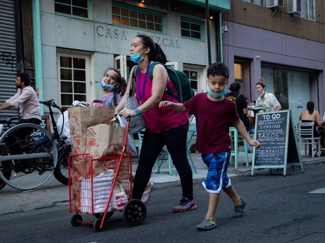 Pedestrians pass customers dining outside Casa Mezcal in New York City.