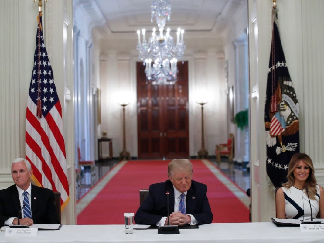 President Donald Trump, Vice President Mike Pence, left, and first lady Melania Trump, attend a "National Dialogue on Safely Reopening America's Schools," event in the East Room of the White House on Tuesday.