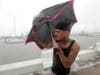 Chris Headen battles with his umbrellas as Hurricane Hanna begins to make landfall, Saturday, July 25, 2020, in Corpus Christi, Texas. 