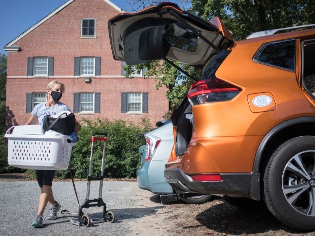 Darlene Genander loads up her vehicle as she helps junior UNC-Chapel Hill student Caitlin Sockin move out of Alderman Residence Hall in Chapel Hill, N.C..