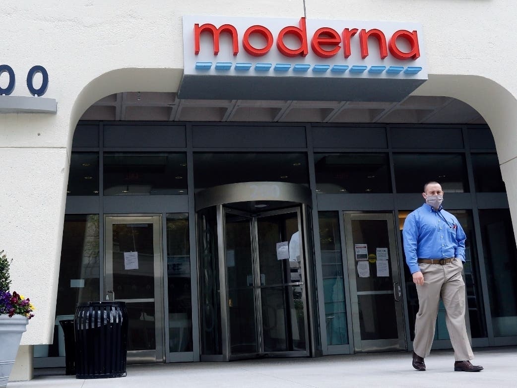 A man stands outside an entrance to the Moderna Inc. building in Cambridge, Mass. A second COVID-19 vaccine is moving closer to joining the U.S. fight against the pandemic.