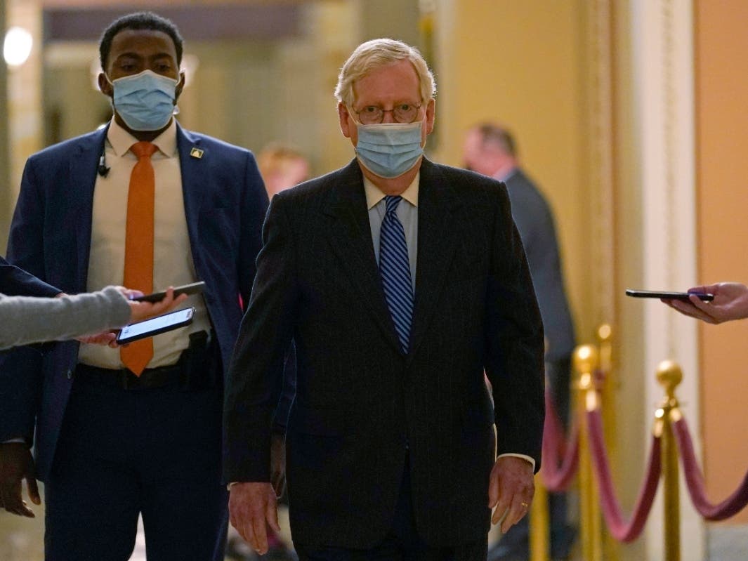 In this file photo,  Senate Majority Leader Mitch McConnell of Ky. walks past reporters on Capitol Hill in Washington.