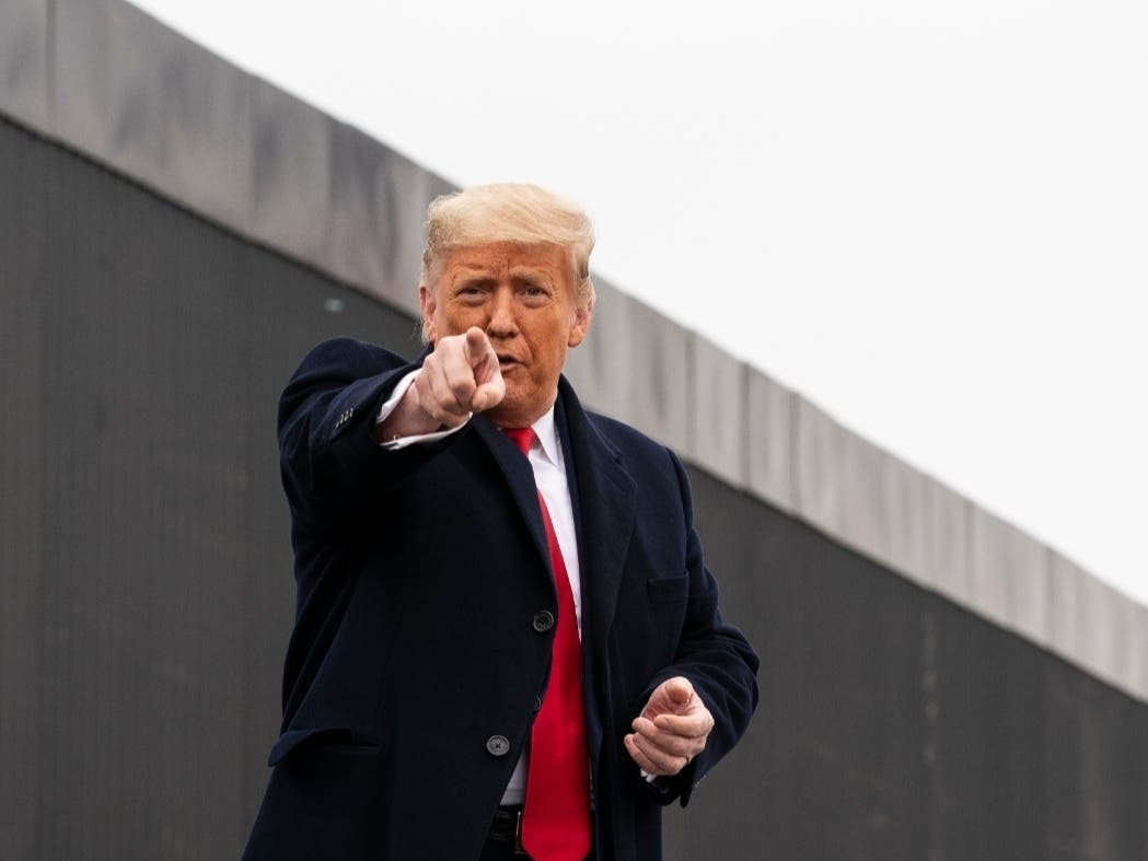 President Donald Trump points to a member of the audience after speaking near a section of the U.S.-Mexico border wall on Tuesday.