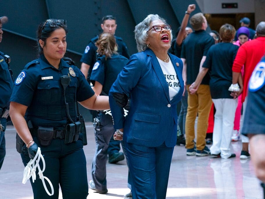 Rep. Joyce Beatty (D-OH), chairwoman of the Congressional Black Caucus, is taken into custody Thursday by U.S. Capitol Police officers in the Hart Senate Office Building in Washington.