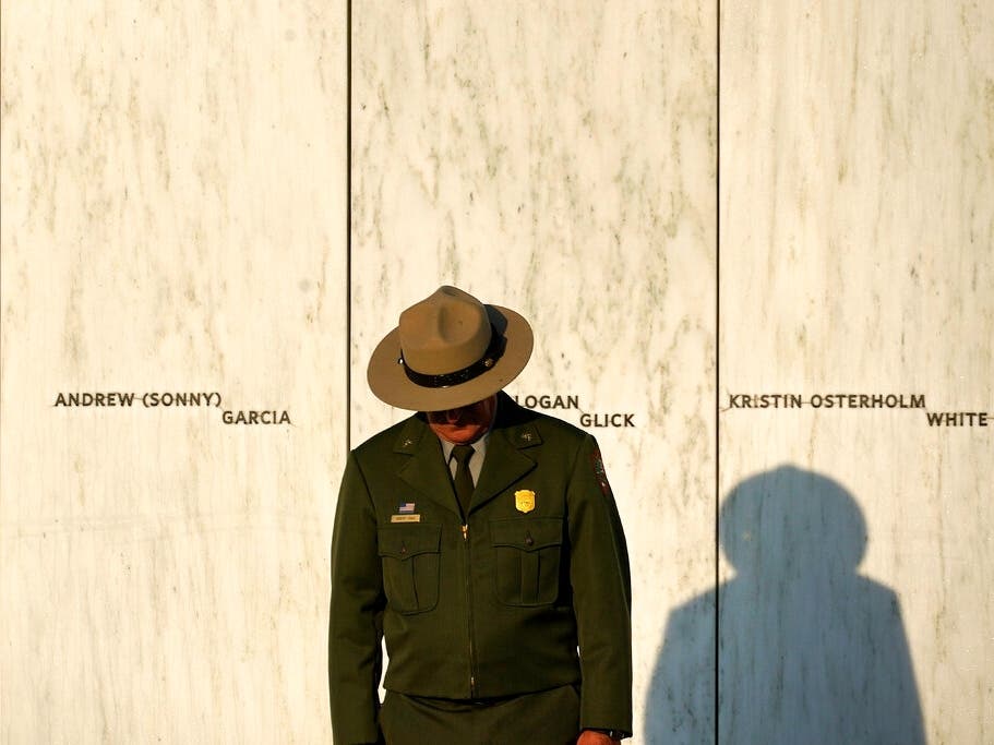 A National Park Service ranger stands in front of the Wall of Names at the Flight 93 National Memorial in Shanksville, Pa., before Saturday's Service of Remembrance. 