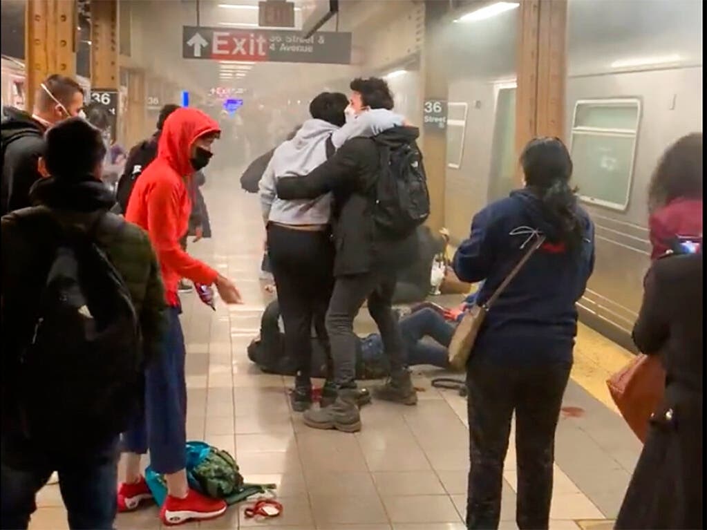 A gunman filled a rush-hour subway train with smoke and shot multiple people Tuesday, leaving wounded commuters bleeding on a Brooklyn platform as others ran screaming.