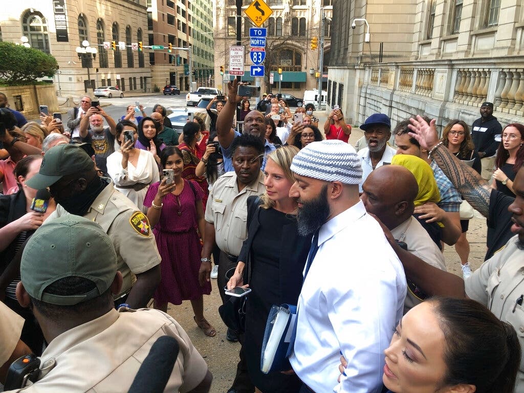 Adnan Syed, center, leaves the Cummings Courthouse in Baltimore. A judge ordered the release of Syed in October 2022 after overturning his conviction for a 1999 murder that was chronicled in the hit podcast "Serial." 
