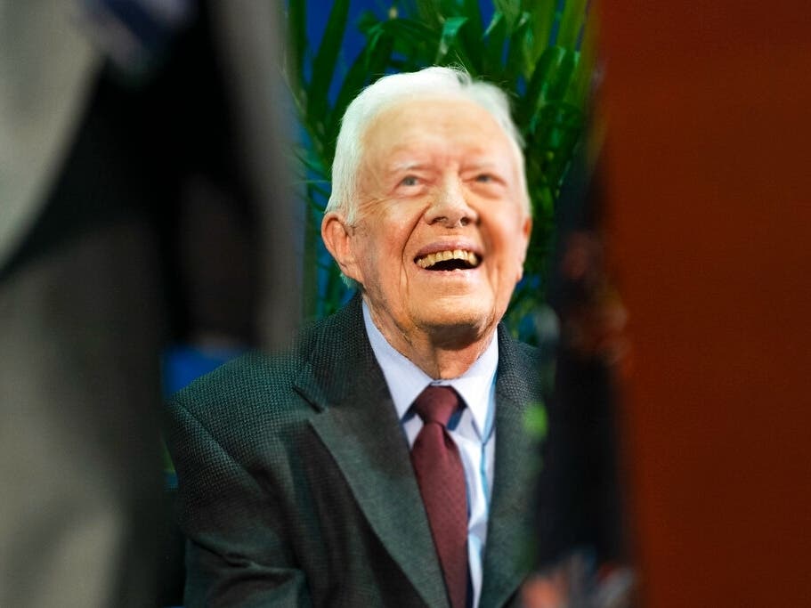 Former President Jimmy Carter listens as students and guests sing happy birthday to him during an annual Carter Town Hall.