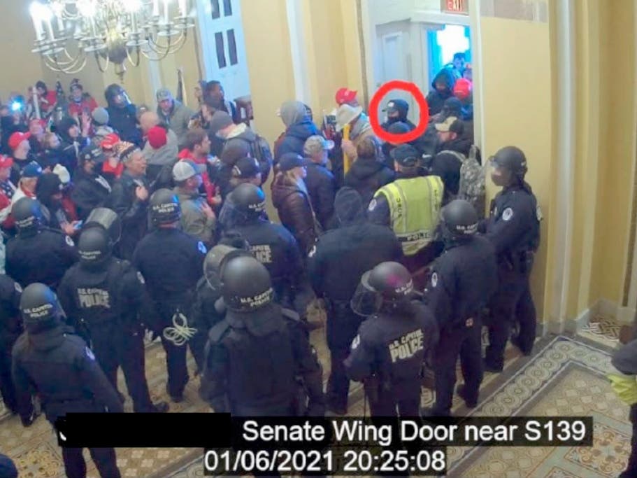 In this image from U.S. Capitol Police video, released and annotated by the Justice Department in the Statement of Facts supporting an arrest warrant, David Elizalde, circled in red, appears on security video inside the U.S. Capitol on Jan. 6, 2021.