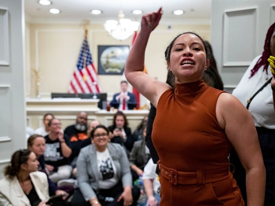 Yareliz Mendez Zamora leads a chant for dozens of activists during a sit-in Wednesday outside Florida Gov. Ron DeSantis' office. Florida lawmakers approved a flurry of bills Wednesday targeting diversity programs at colleges and transgender rights.