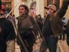  Rioters, including Dominic Pezzola, center with police shield, are confronted by U.S. Capitol Police officers outside the Senate Chamber on Jan. 6, 2021.