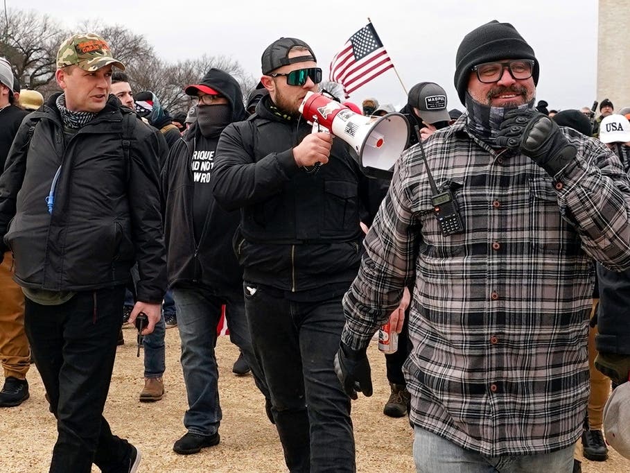 Proud Boys members including Zachary Rehl, left, Ethan Nordean, center, and Joseph Biggs, walk toward the U.S. Capitol in Washington, in support of President Donald Trump on Jan. 6, 2021. 