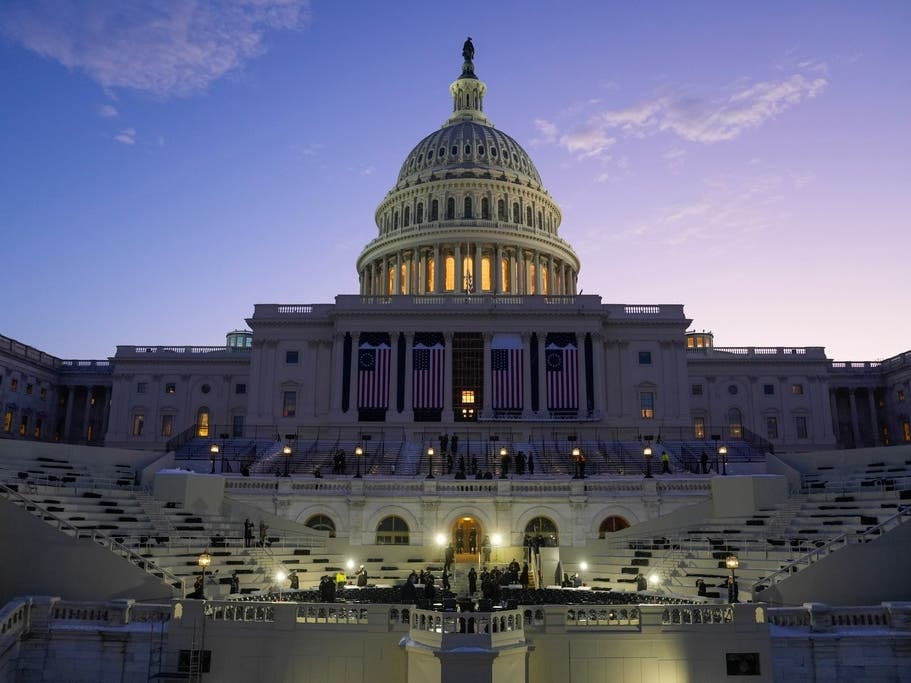 The sun rises behind the U.S. Capitol as a rehearsal begins on the West Front ahead of President-elect Donald Trump's upcoming inauguration in Washington. 