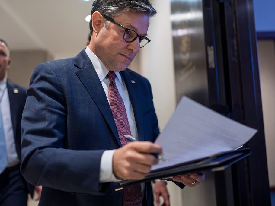 Speaker of the House Mike Johnson, R-La., arrives to talk to reporters after a closed-door meeting with fellow Republicans to find agreement on a spending bill. 