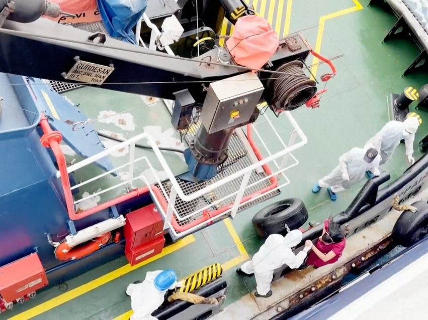 Health workers get off the Dutch-flagged MV Hondius after three passengers died and several others fell seriously ill in a suspected hantavirus outbreak.