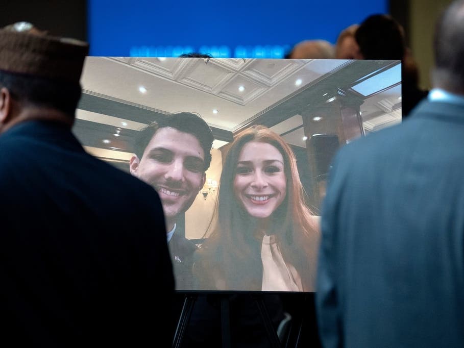 Visitors walk past a photo of slain Israeli Embassy staff members Yaron Lischinsky, left, and Sarah Milgrim, right, before a service to mark the reopening of the Capital Jewish Museum after the two were killed following an event at the museum in 2025.