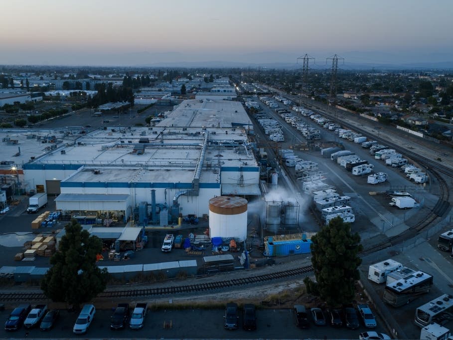 Water is sprayed on a tank that overheated at an aerospace plant in Garden Grove on Friday.