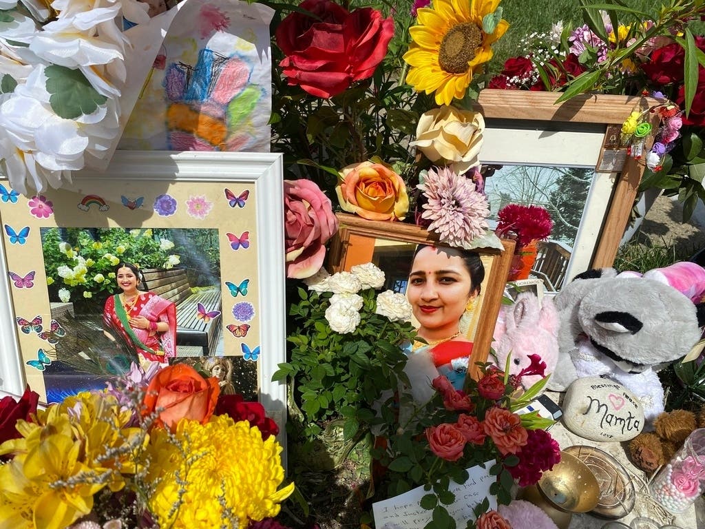 Flowers, candles and photos are placed near Mamta Kafle Bhatt's mailbox in Manassas Park, Va., Sept. 4, 2024.