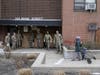 Members of the New York National Guard distribute food to families in New Rochelle Thursday. The area has endured a fast-growing COVID-19 cluster. On Tuesday, Gov. Mario Cuomo declared a 1-mile radius “containment area” in the New York suburb.