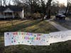A sign showing support for residents is displayed on a lawn in New Rochelle Wednesday. State officials are shuttering several schools and houses of worship for two weeks due to the nation's biggest cluster of coronavirus cases.
