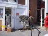 A woman waiting in line at an ATM watches as a cleaning crew works in the bank in New Rochelle, Wednesday. State officials shuttered several schools and houses of worship for two weeks due to the nation's biggest cluster of coronavirus cases.