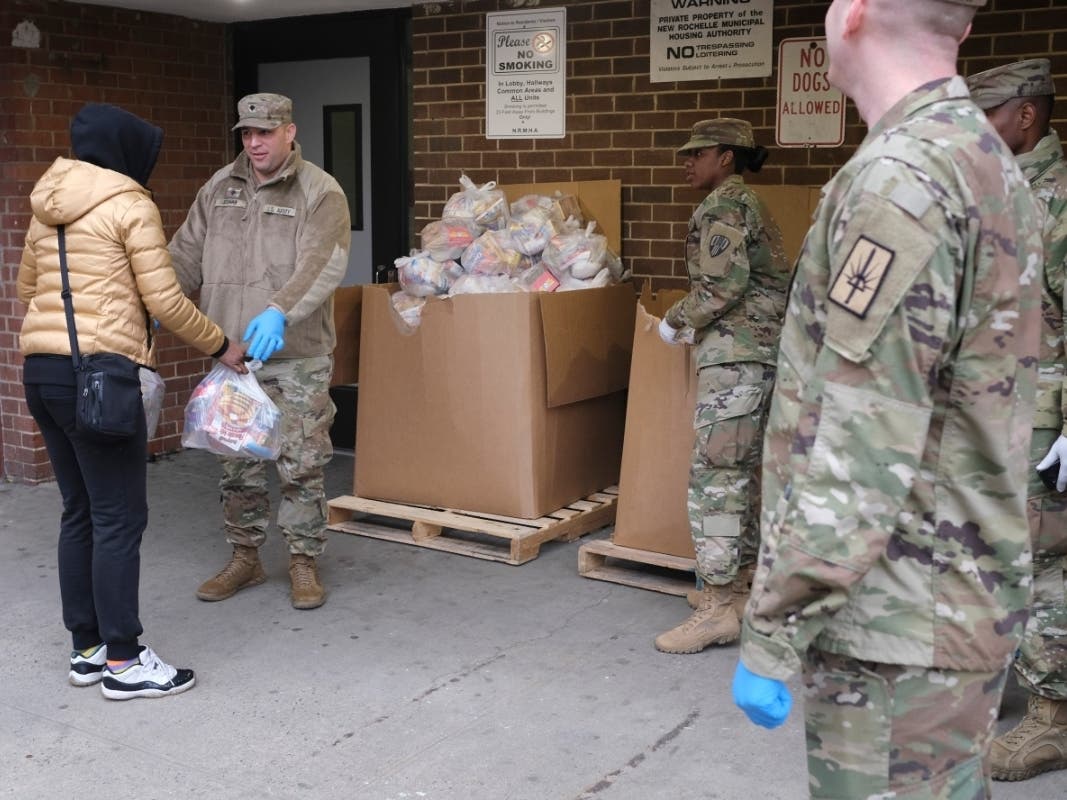 Members of the New York National Guard distribute food to families in New Rochelle Thursday. The area has endured a fast-growing COVID-19 cluster. On Tuesday, Gov. Mario Cuomo declared a 1-mile radius “containment area” in the city.