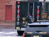 In this image taken from video, Hudson County SWAT team officers arrive at the scene following reports of gunfire Tuesday in Jersey City, New Jersey. 