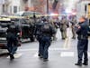 Police officers gather near the scene following reports of gunfire Tuesday in Jersey City, New Jersey.
