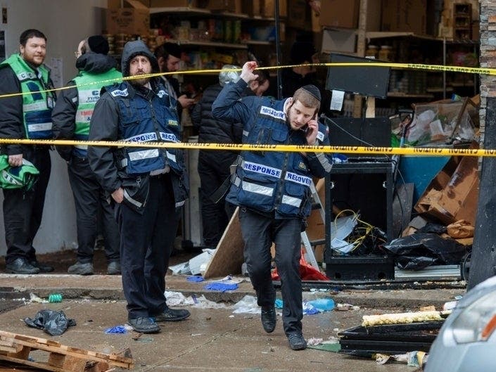  Responders work to clean up the scene of a shooting that left multiple dead at a kosher market on Dec. 11, 2018, in Jersey City, NJ. Police killed two gunmen who had earlier killed an officer at a cemetery in Jersey City.