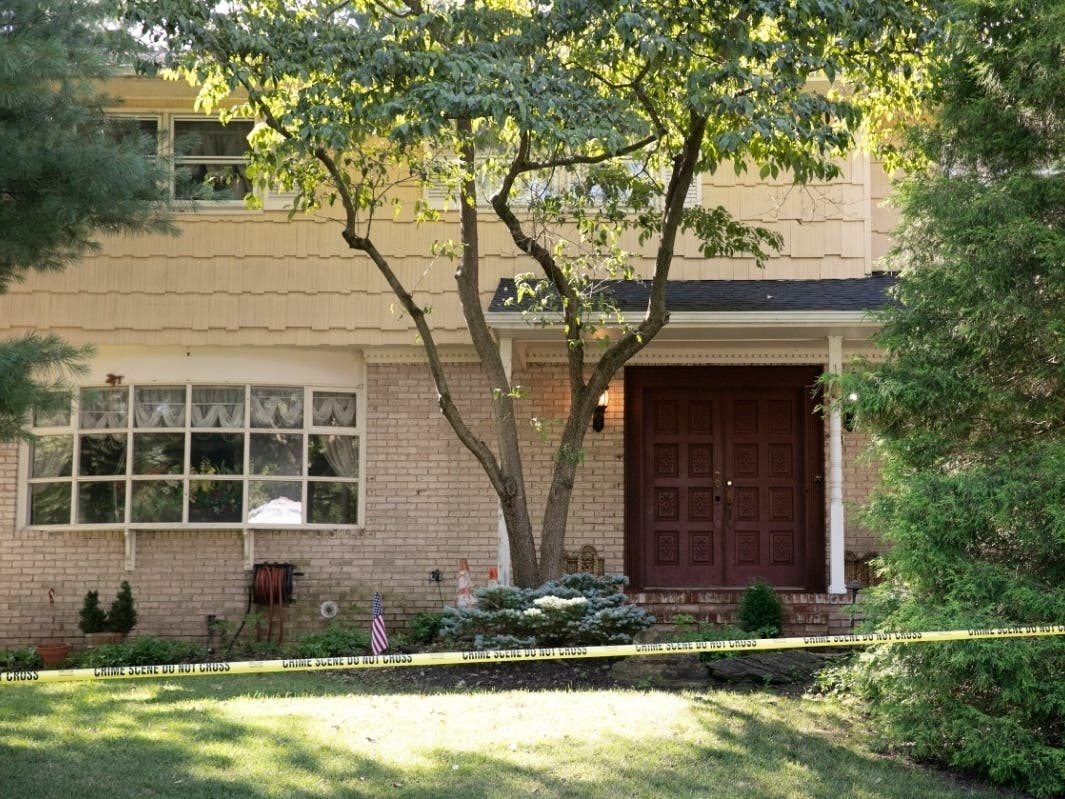 Crime scene tape surrounds the home of U.S. District Judge Esther Salas, Monday, July 20, 2020, in North Brunswick, N.J. A gunman posing as a delivery person shot and killed Salas' 20-year-old son and wounded her husband Sunday evening.