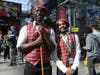 Cosplayers dressed as characters from the movie "Coming to America" pose for a photo during the second day of New York Comic Con, Friday, Oct. 4, 2019, in New York