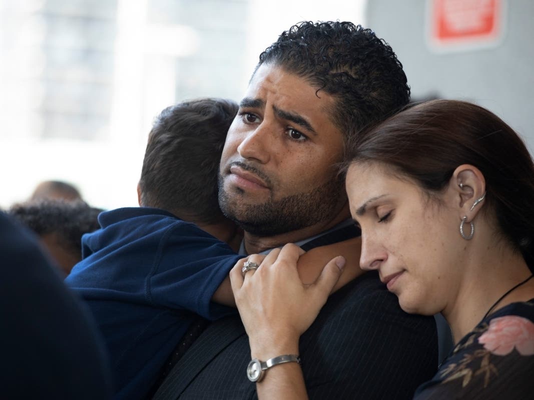 Juan Rodriguez, holding his son Tristan, leaves Bronx Criminal Court with his wife Marissa after a hearing Aug. 1, 2019 in New York. Rodriguez has pleaded not guilty to manslaughter and other charges in the hot-car deaths of their twins.