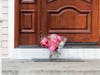Flower bouquets rest on the doorstep of a rabbi's residence in Monsey, N.Y., Sunday, Dec. 29, 2019, following a stabbing Saturday night during a Hanukkah celebration. 